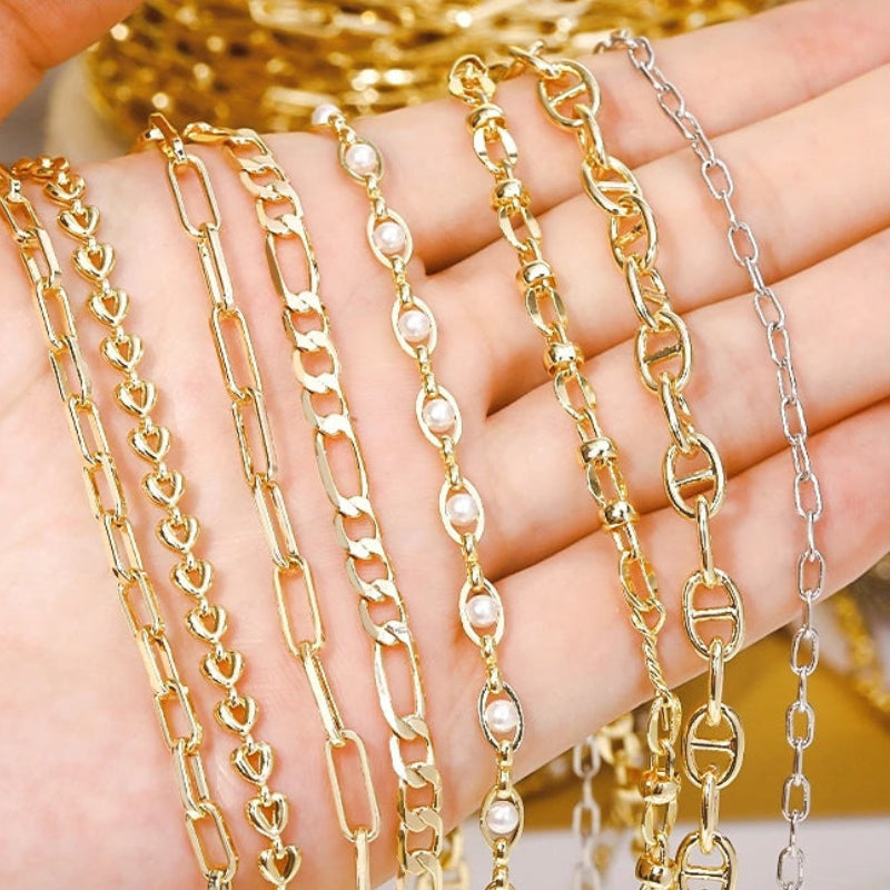 Gold and silver chain necklaces on a hand.