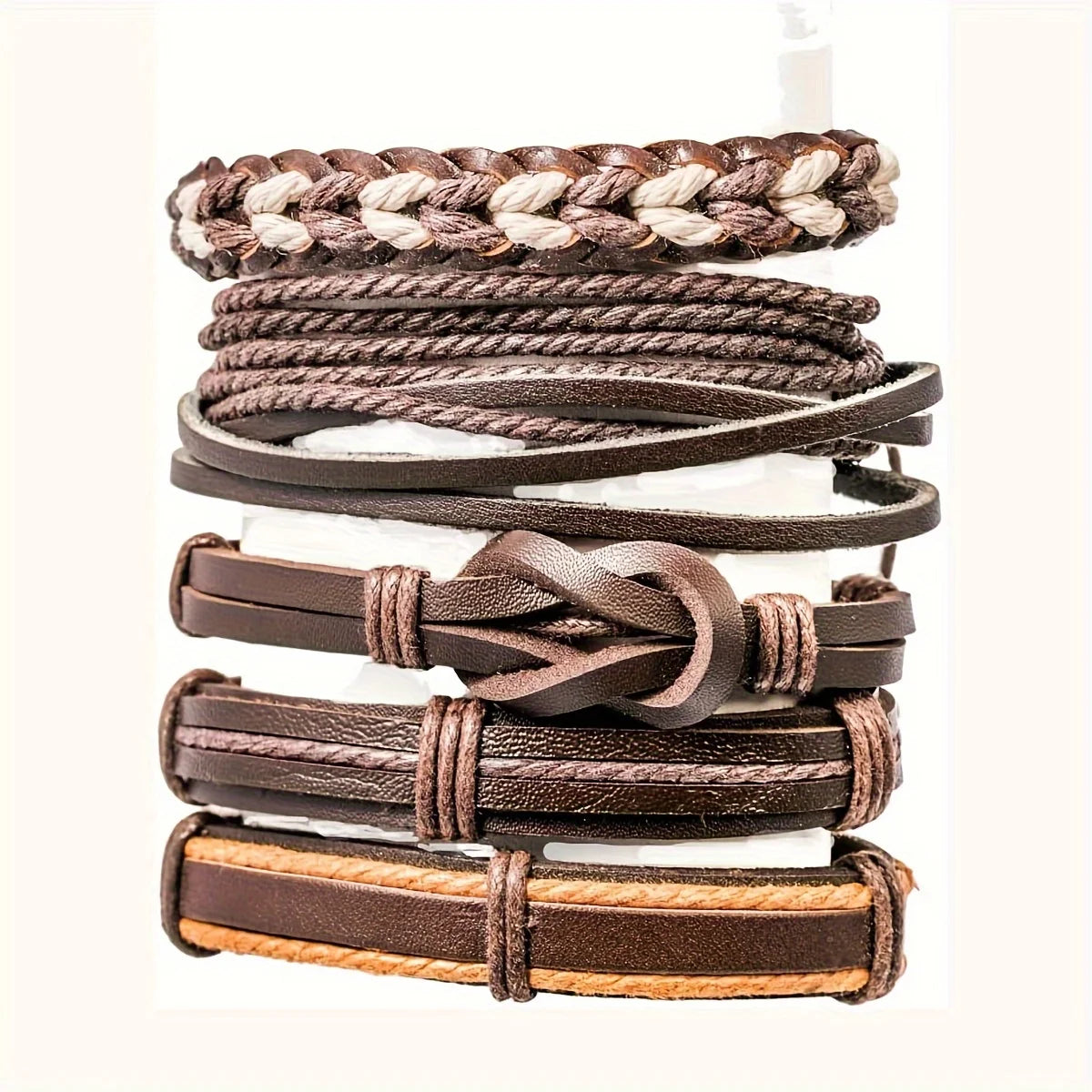 Stack of brown leather bracelets on a white background