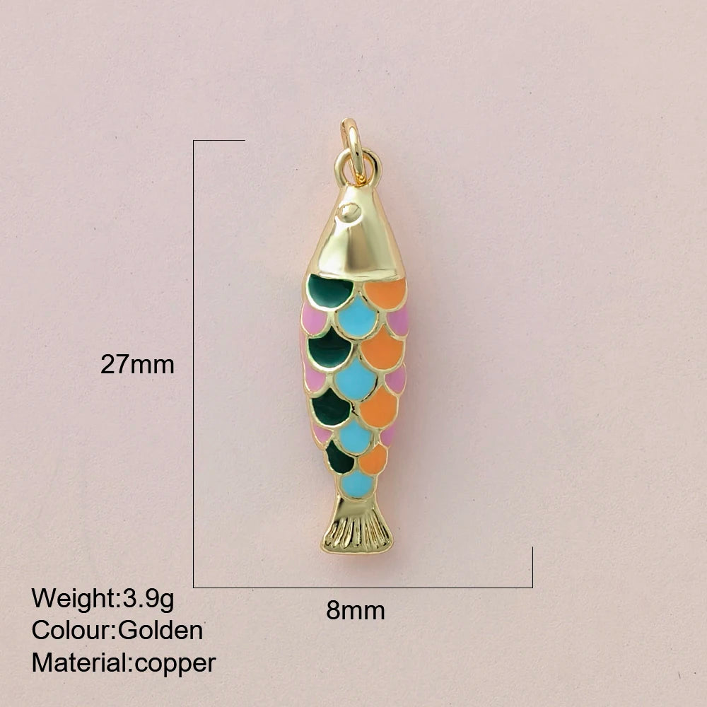 Colorful fish-shaped pendant with gold accents on a light pink background