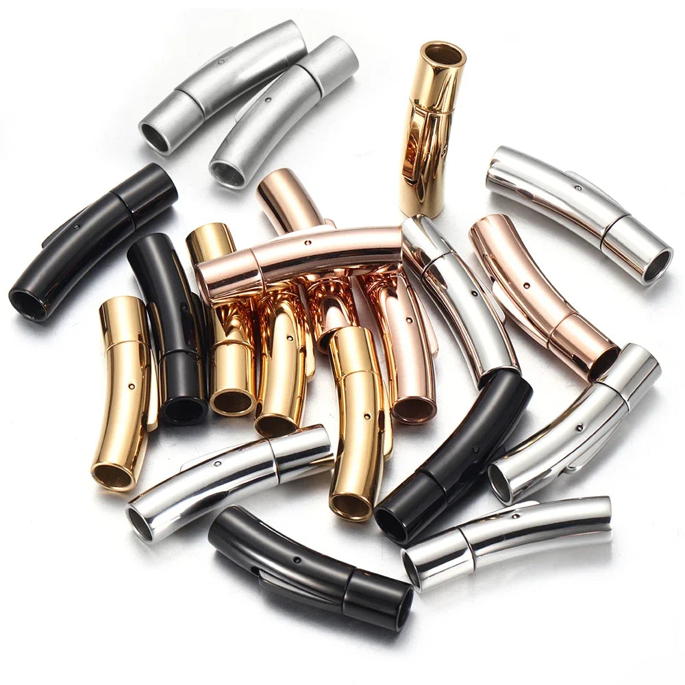 A collection of jewelry clasps in polished silver, rose gold, and black finishes, arranged on a plain white background.