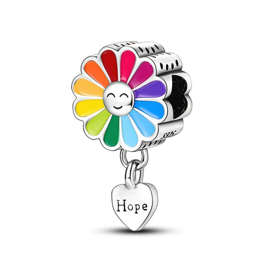 Colorful flower-shaped charm with a heart pendant labeled 'Hope' on a white background
