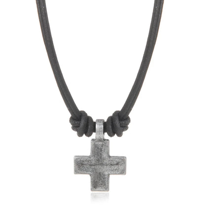 Necklace with a black cord and silver cross pendant on a white background