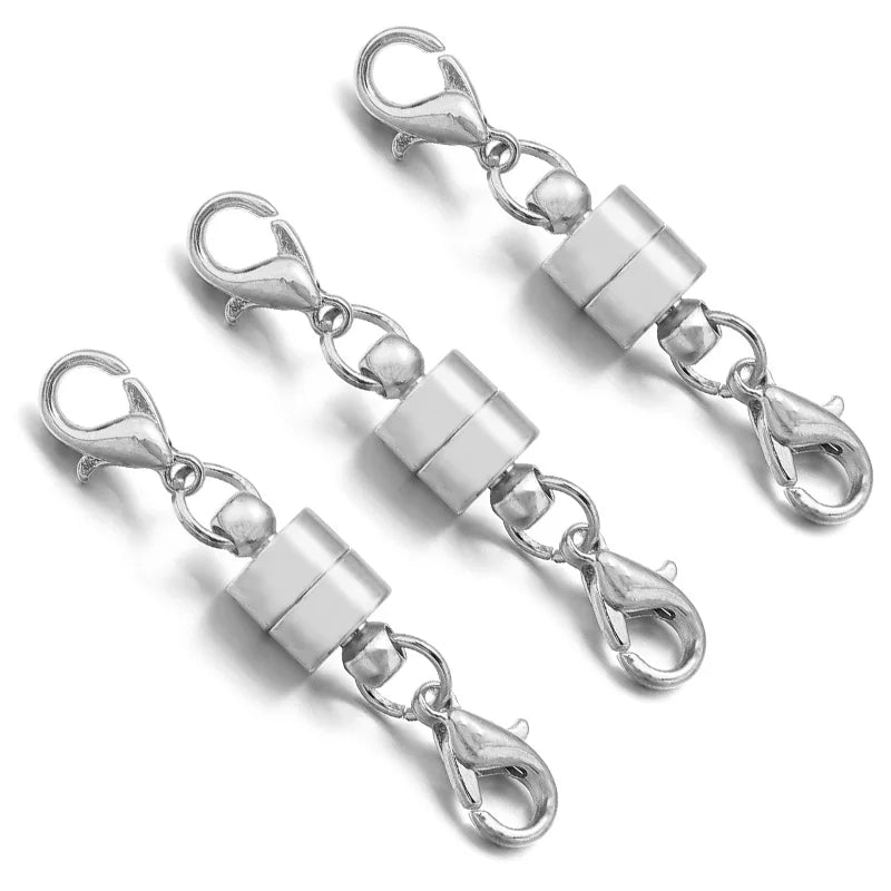 Three silver chain extender  clasp connectors on a white background