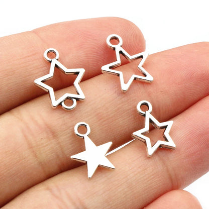 Silver star-shaped charms on a hand against a white background