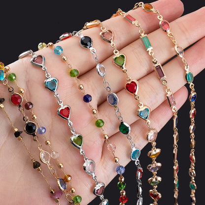 Colorful beaded necklaces on a hand against a black background