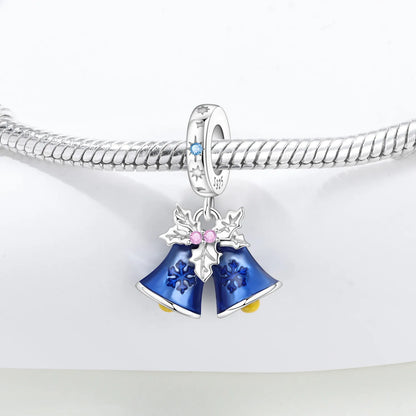 Silver Holiday charm with blue bell design on a white background