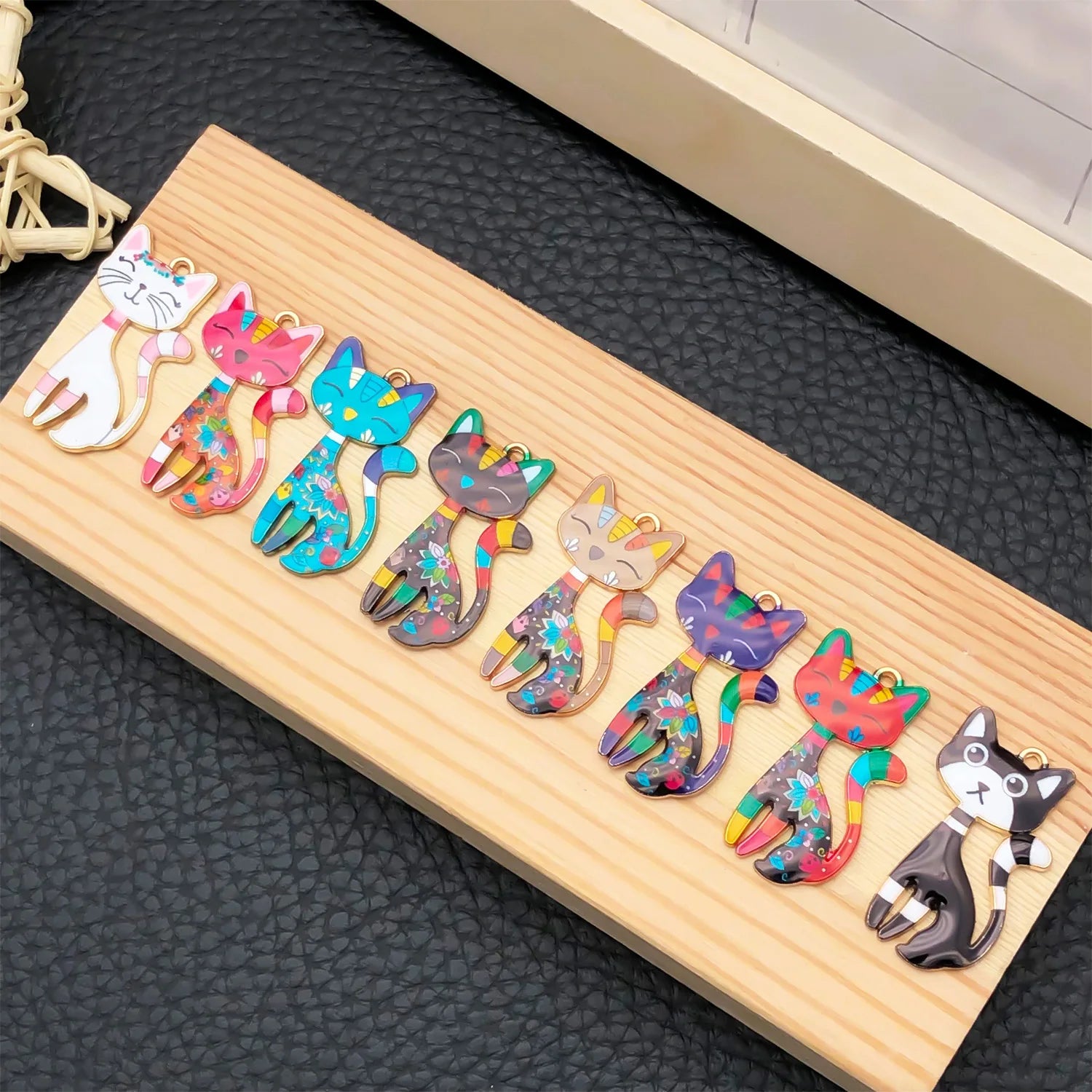 Colorful cat-shaped hair clips on a wooden board