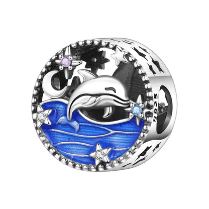 Silver charm with a dolphin design on a blue background