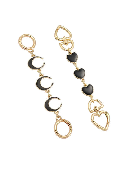 Gold and black heart, moon, and bag extender on a white background