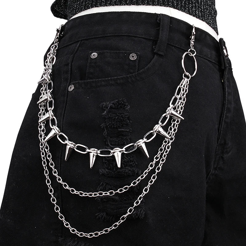Black pants with a silver chain belt featuring spikes worn by a person.