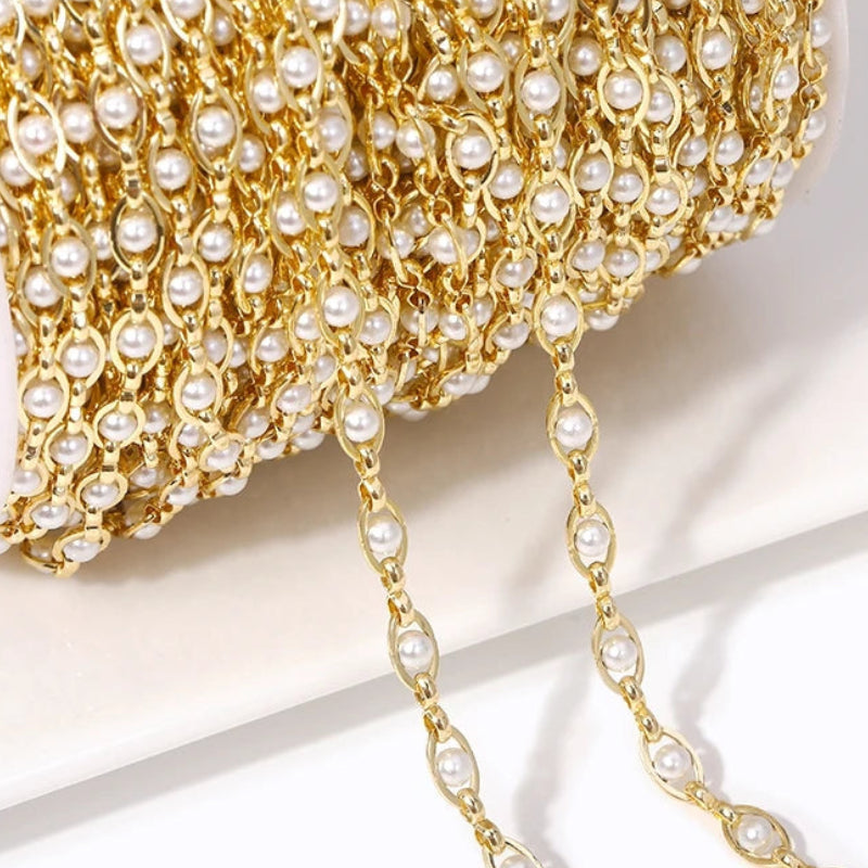 Gold chain with pearls on a light background
