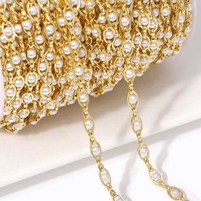 Gold chain with pearls on a light background