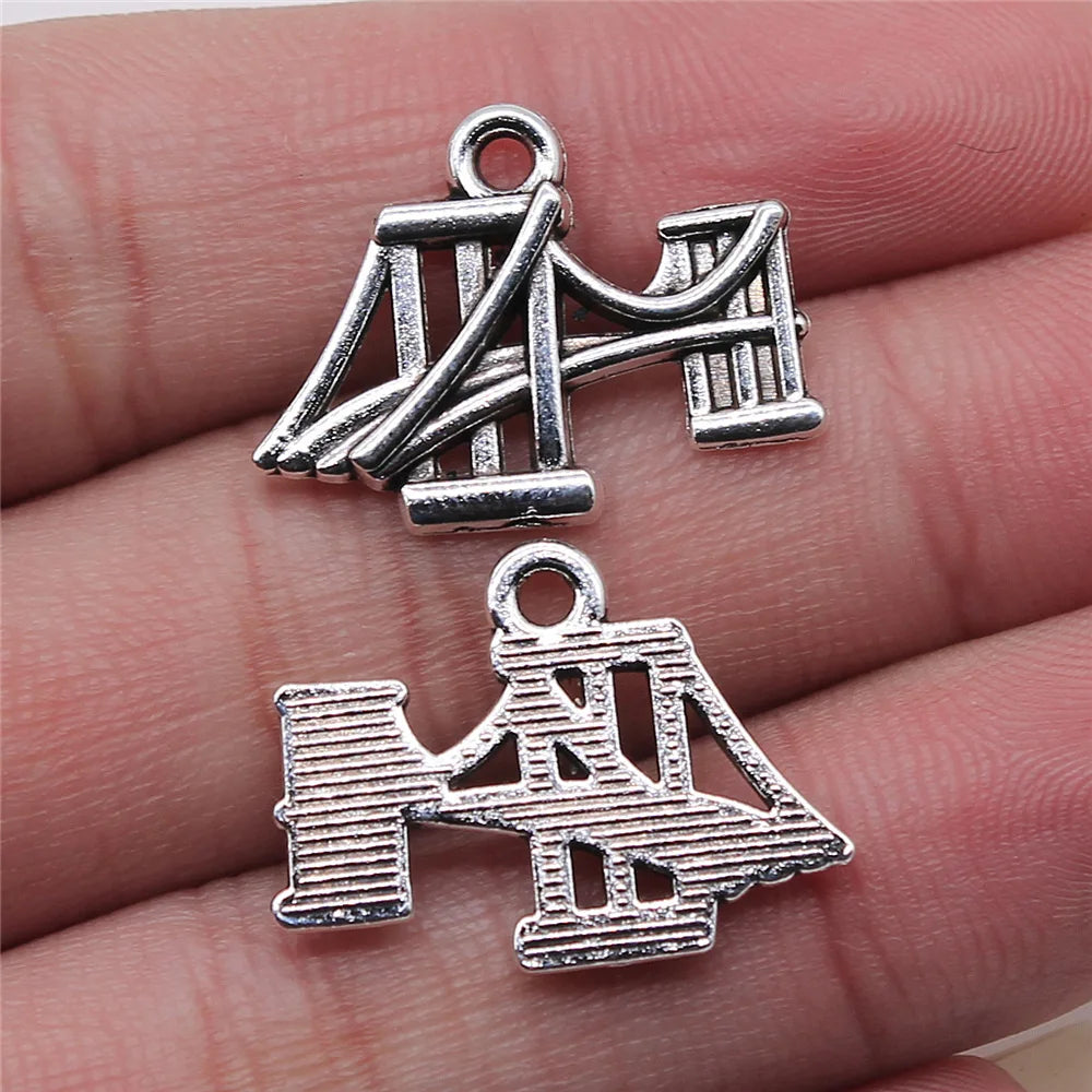Travel charms for jewelry making featuring airplane, passport, suitcase and camera charms.