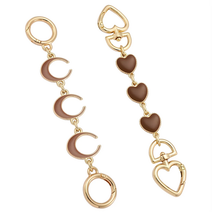 Gold and brown heart, moon, and circle bag chain on a white background