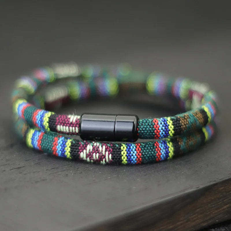 Multicolored beaded bracelet with a black clasp on a dark surface