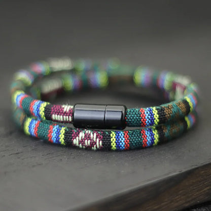 Multicolored beaded bracelet with a black clasp on a dark surface