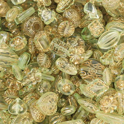 Close-up of a pile of transparent and gold-colored decorative beads.