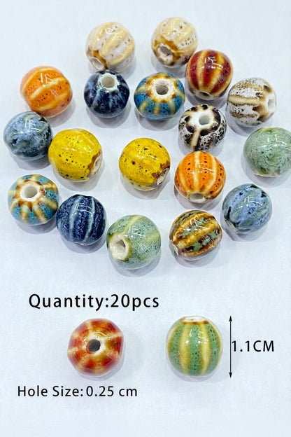 A set of 20 handmade ceramic beads in various colorful patterns and glazes, displayed on a white background with text indicating quantity, hole size, and bead dimensions.