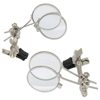 Set of magnifying glasses with adjustable clamps on a white background