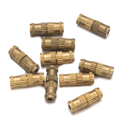 Gold-colored metal connectors on a white background