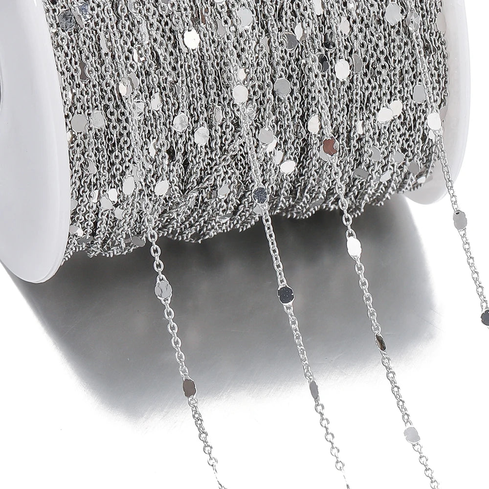 Close-up of silver chain necklace on a white background