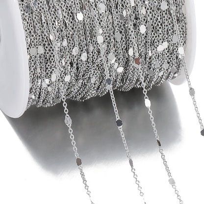 Close-up of silver chain necklace on a white background
