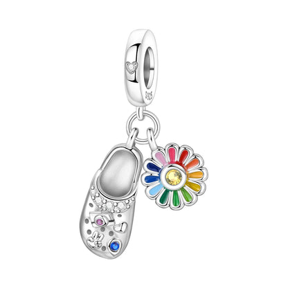 Silver charm with a Dutch wooden shoe and colorful flower on a white background