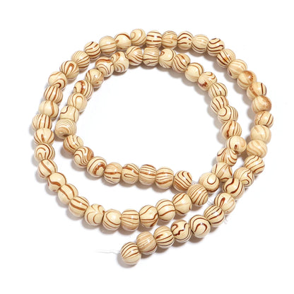 Three beige beaded bracelets stacked on a white background