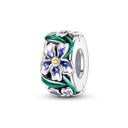 Silver charm with floral design on a white background