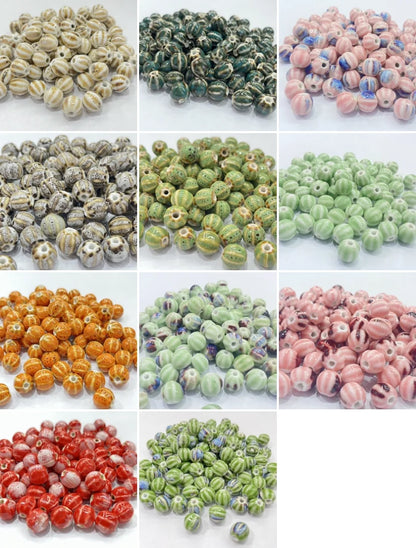 A 4x3 grid showing twelve different piles of round glass beads in various colors and patterns, including striped, speckled, and marbled designs in beige, green, pink, orange, and red.