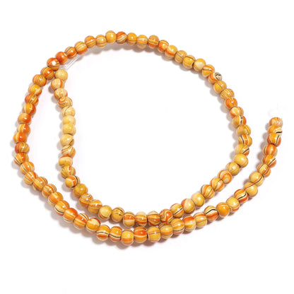 Beaded necklace with orange and yellow beads on a white background