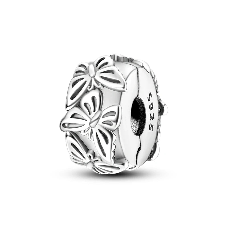 Silver charm with butterfly design on a white background