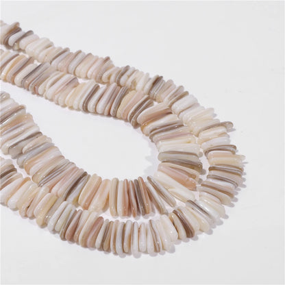 Multi-strand mother of pearl shell bead necklace featuring elongated, curved bar-shaped beads in natural beige, cream, and light brown tones, arranged on a plain white background.