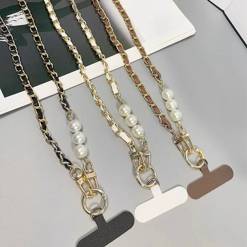 Three pearl necklace extensions on a gray surface with a white card.