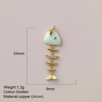 Gold fish-shaped pendant with measurements and material details on a pink background