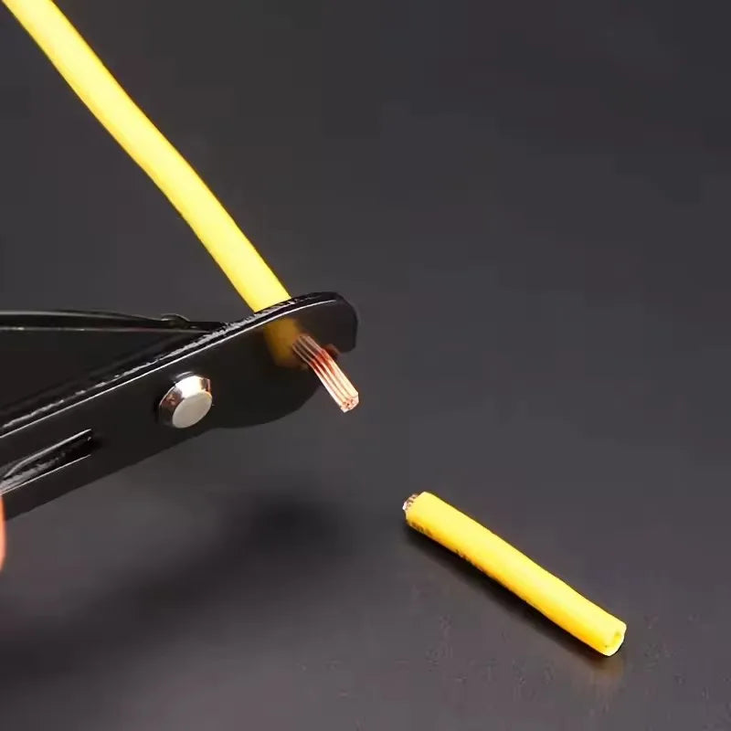 A close-up of a black wire stripping tool cutting a yellow cable, with the exposed copper wire strands visible and a small stripped section placed on a dark surface.