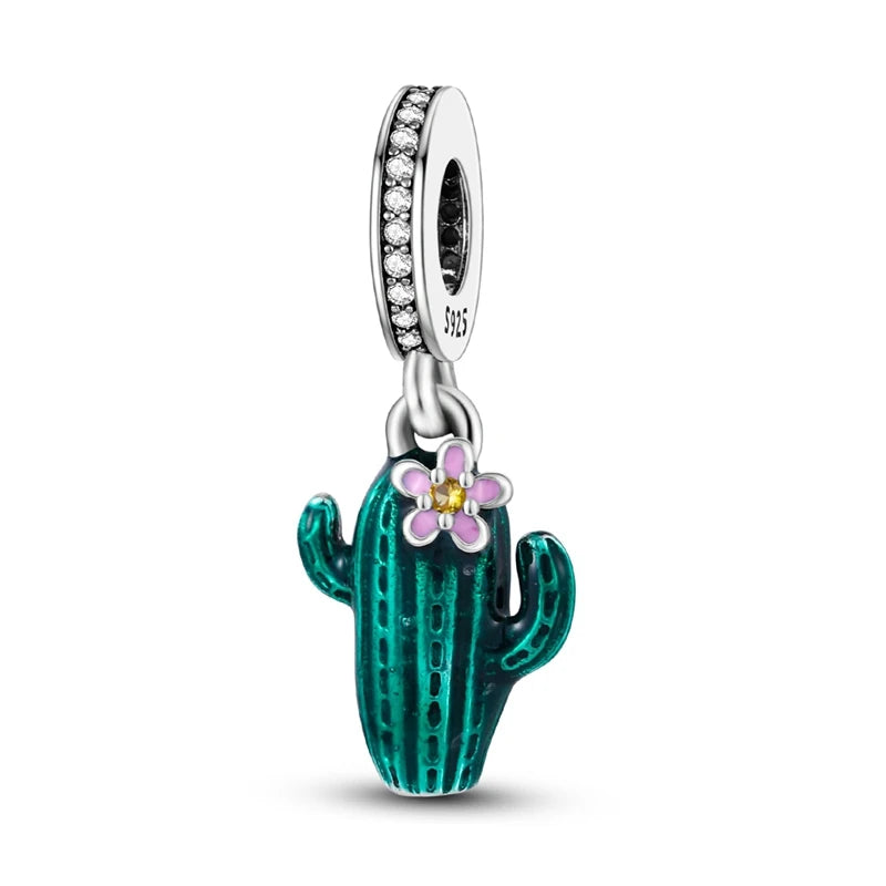 Silver charm shaped like a cactus with a pink flower on a white background