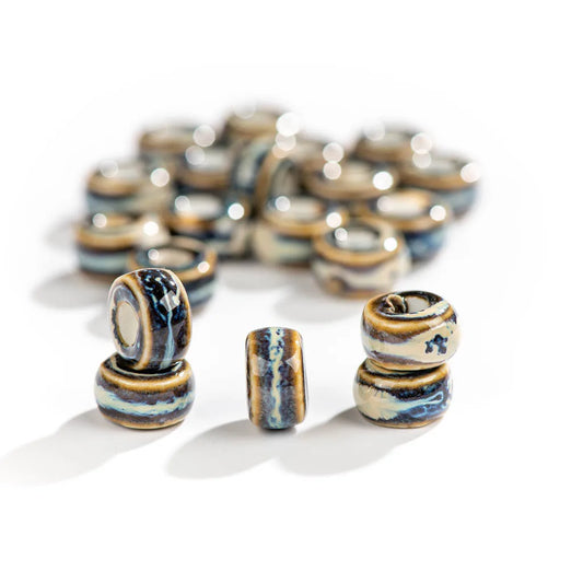 Ceramic beads with blue and brown patterns on a white background