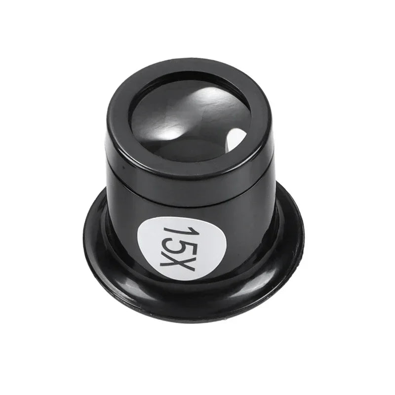 A black cylindrical magnifying lens accessory with a circular white sticker labeled '15X' on the side, shown on a plain white background.