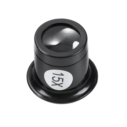 A black cylindrical magnifying lens accessory with a circular white sticker labeled '15X' on the side, shown on a plain white background.