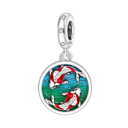 Silver charm with koi fish design on a white background