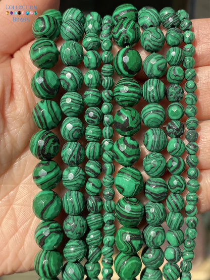 Multiple strands of green malachite beads with natural swirling patterns, held in a person's hand.