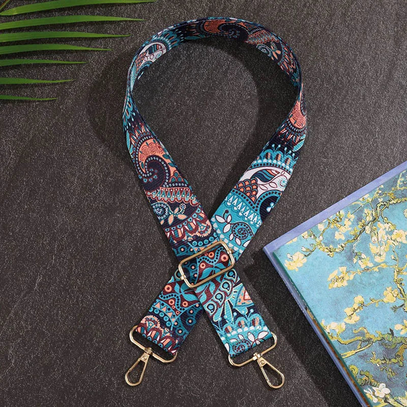 Colorful patterned strap with gold hardware on a dark surface