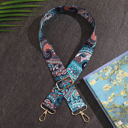 Colorful patterned strap with gold hardware on a dark surface