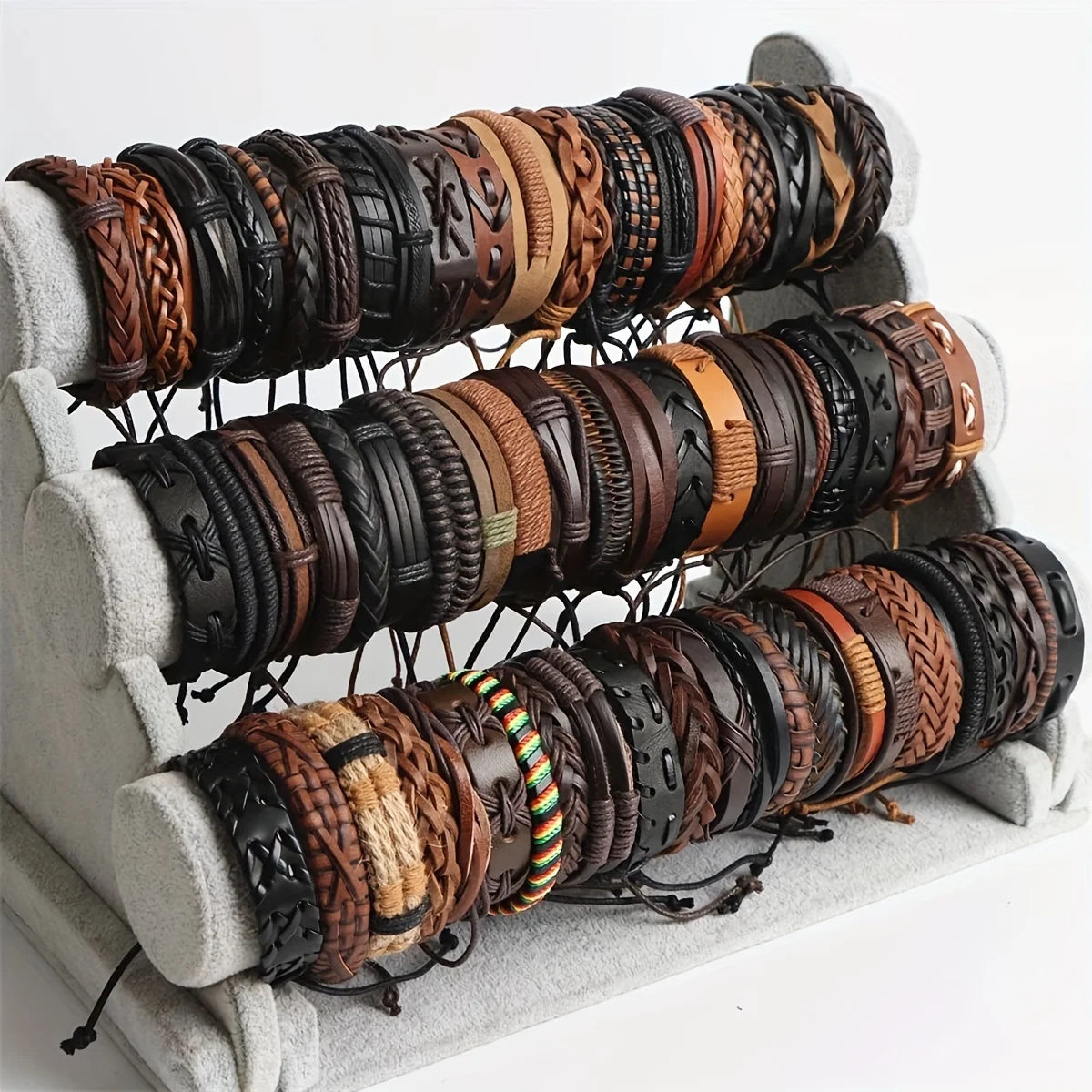 Collection of various leather bracelets on a display stand.