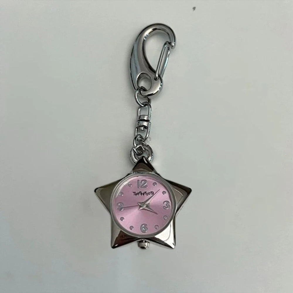 Star-shaped watch charm with pink face and silver metal details on a white background