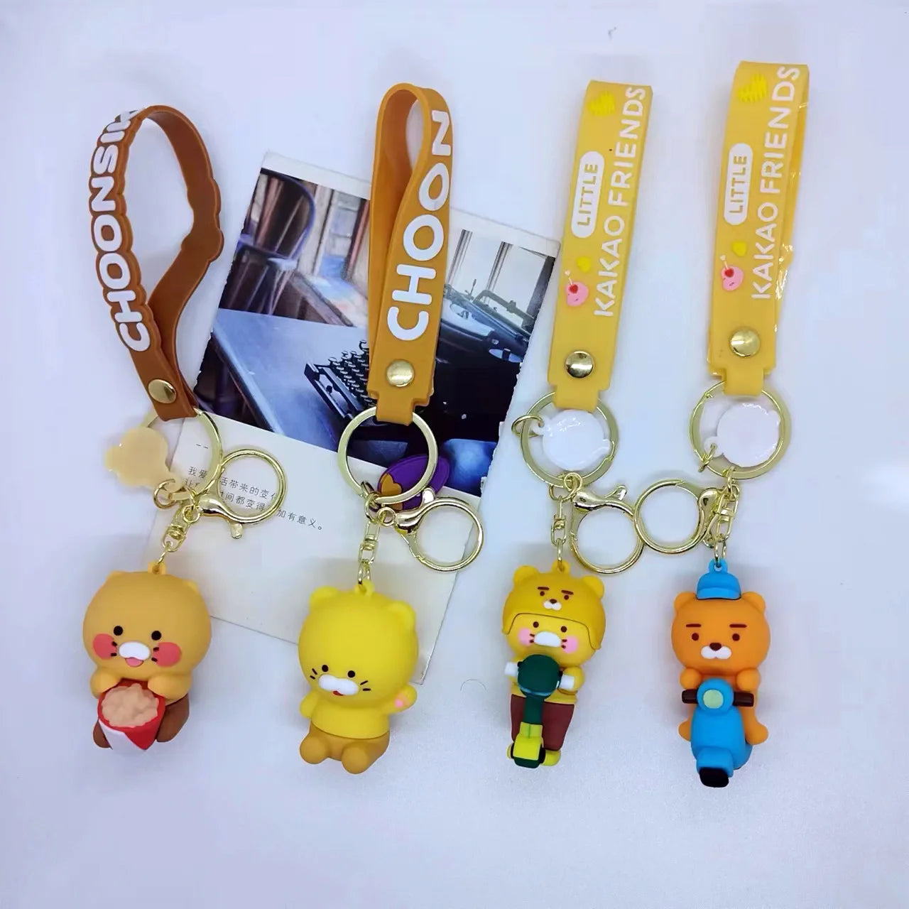 Four cartoon character keychains with 'Kakao Friends' branding on a white background.