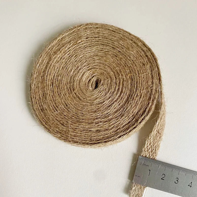 Roll of jute twine with a ruler for scale on a white background
