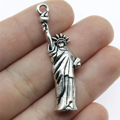 Travel charms for jewelry making featuring airplane, passport, suitcase and camera charms.