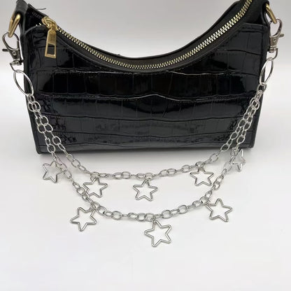 Black handbag with a chain strap featuring star charms on a white background